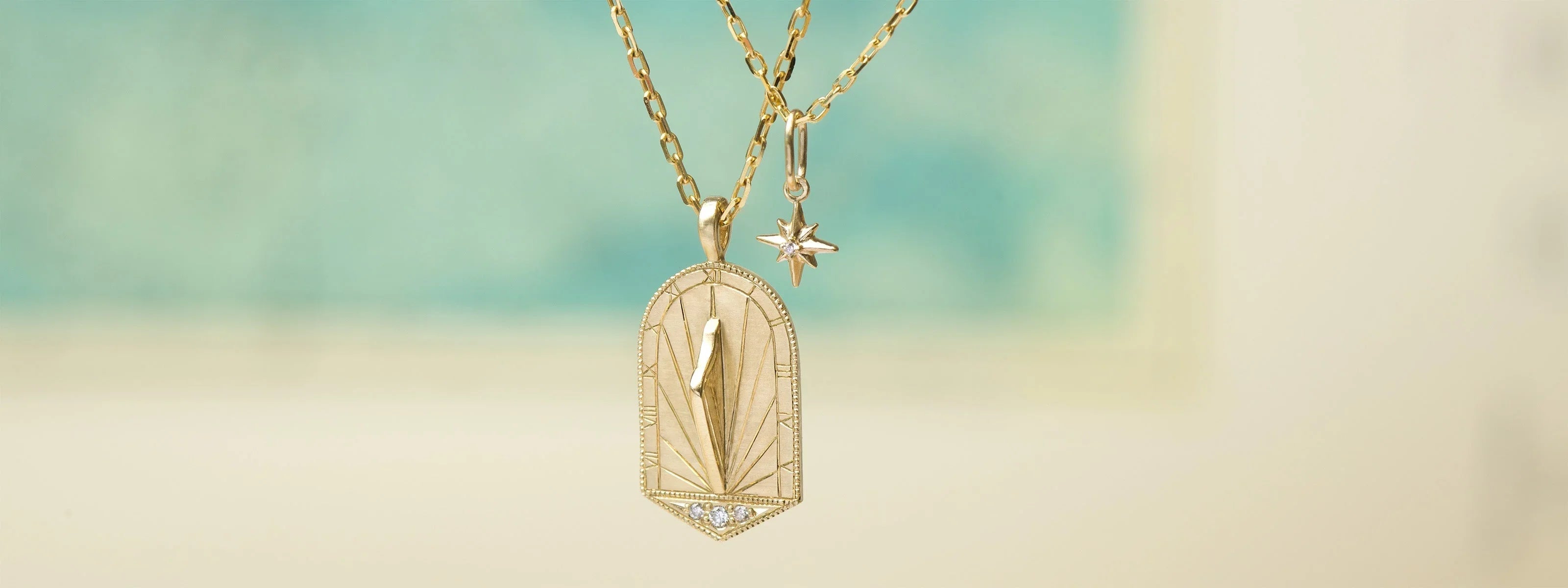 Hand-fabricated gold sundial pendant with diamond accents and star charm, warm natural light