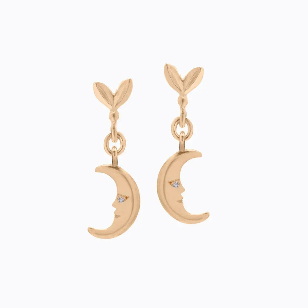 Elegant pair of hand-fabricated gold moon face earrings with diamond detail on white background