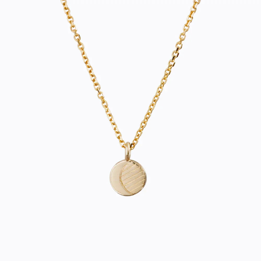 Elegant gold moon phase pendant necklace with engraved crescent detail on clean white background