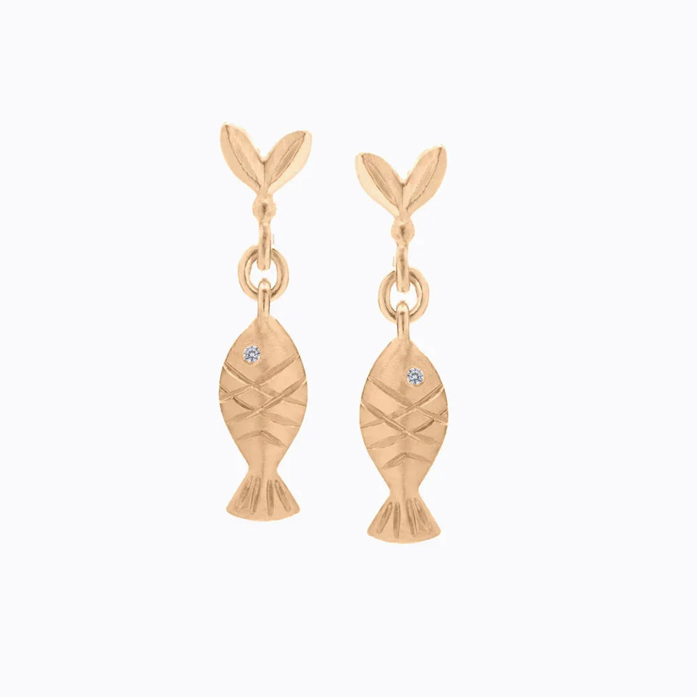 Delicate Fairmined gold fish-shaped drop earrings with hand-engraved details and small diamond accents on white background