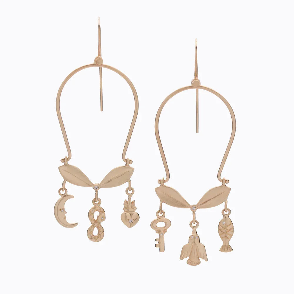 Hand-fabricated 18k gold earrings with leaf motif and symbolic charms, soft natural lighting on white background