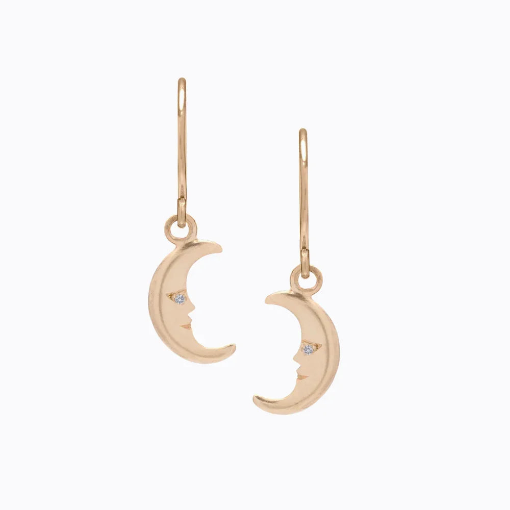 Delicate 14k gold crescent moon face earrings with diamond eyes, minimalist white background