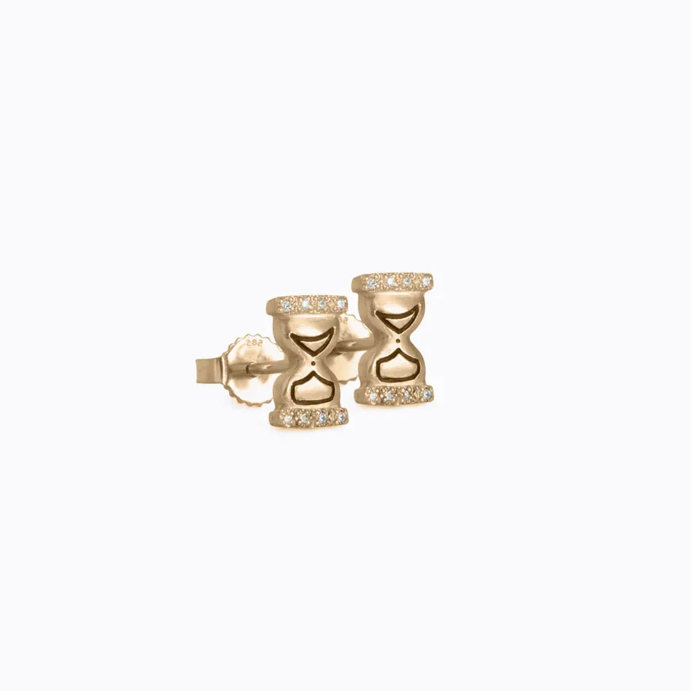 Handcrafted 18k gold hourglass stud earrings with diamond accents on clean white background