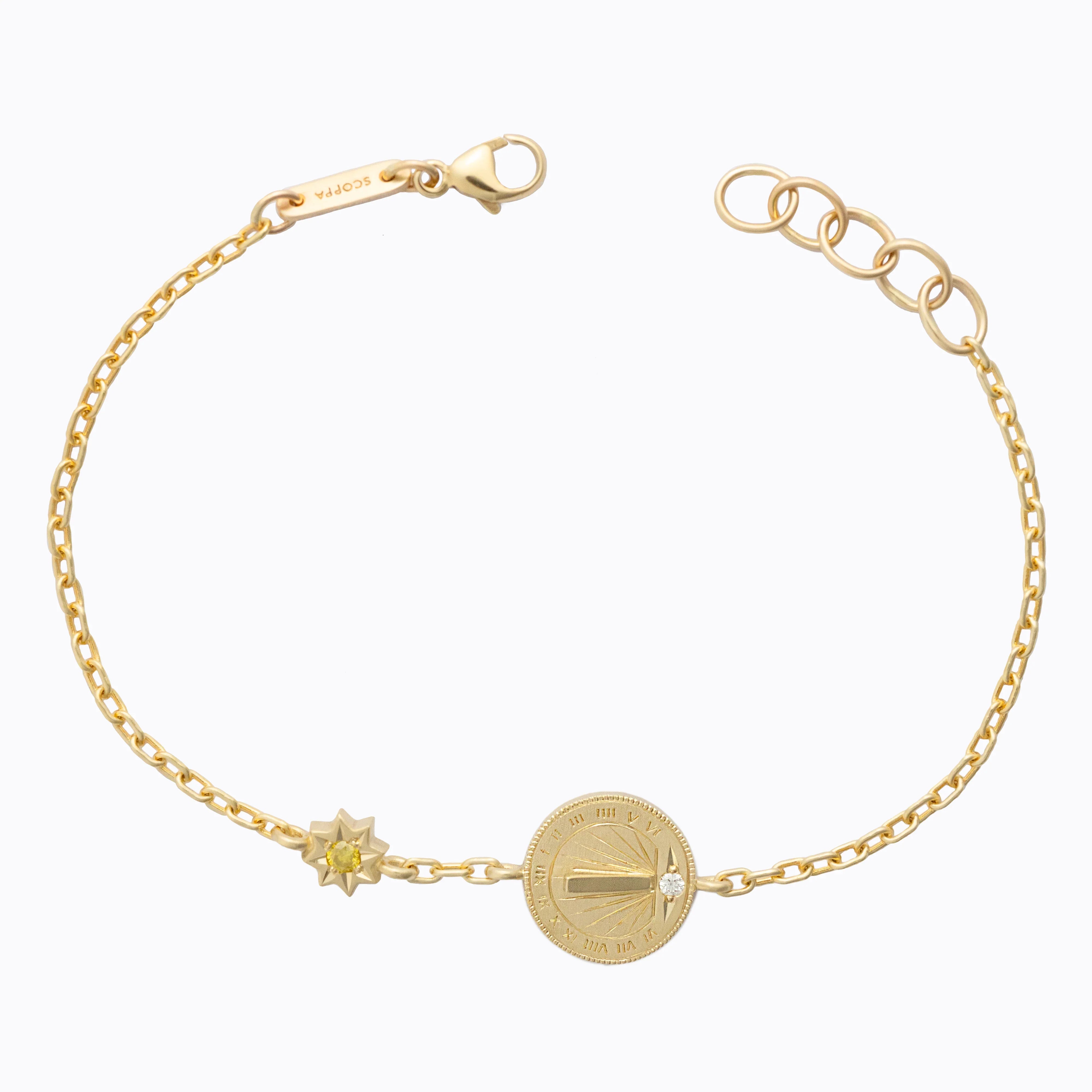 Delicate Fairmined gold sundial bracelet with star detail and tiny diamond on neutral white background
