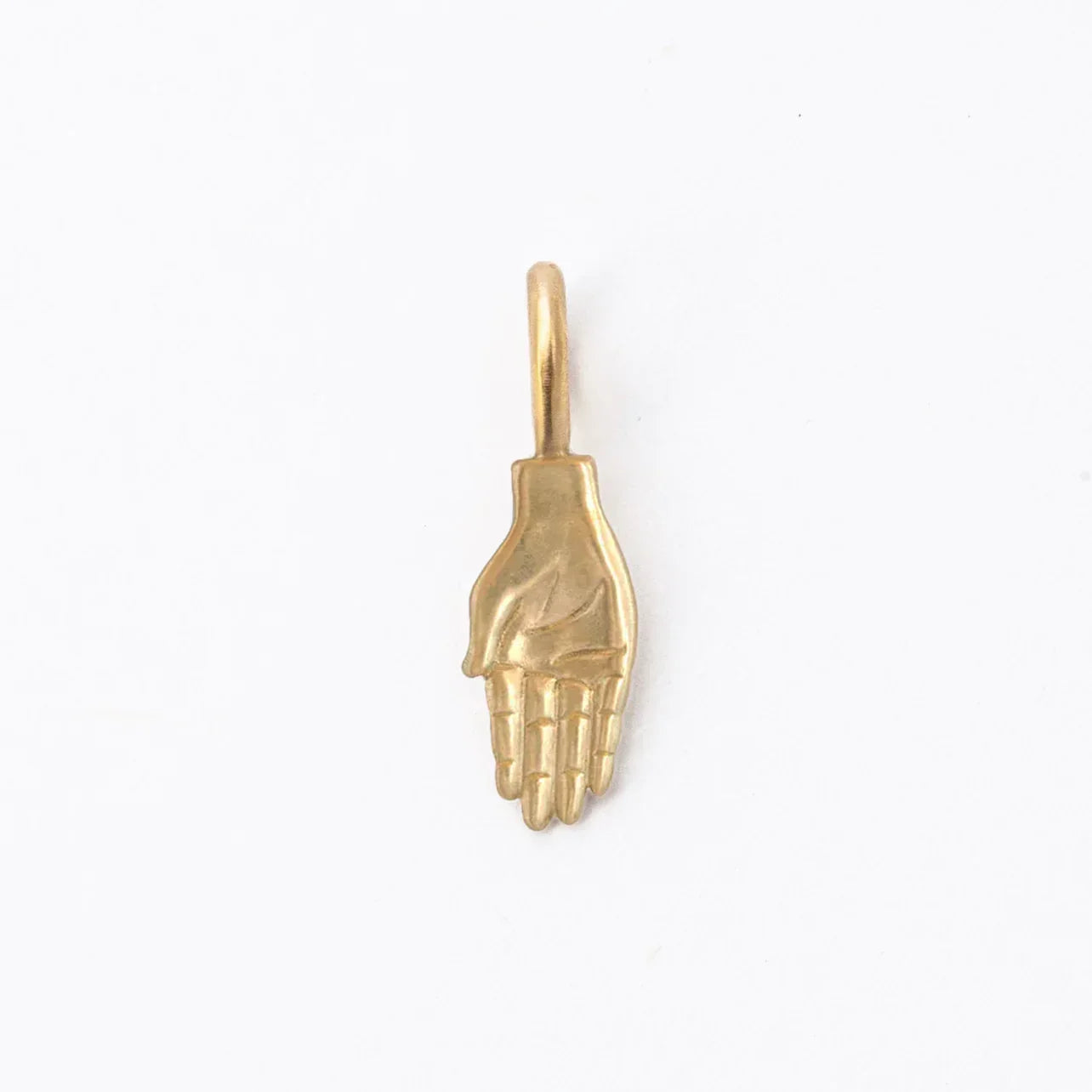 Handcrafted gold pendant shaped like an open palm hand, minimalist white background, warm natural light
