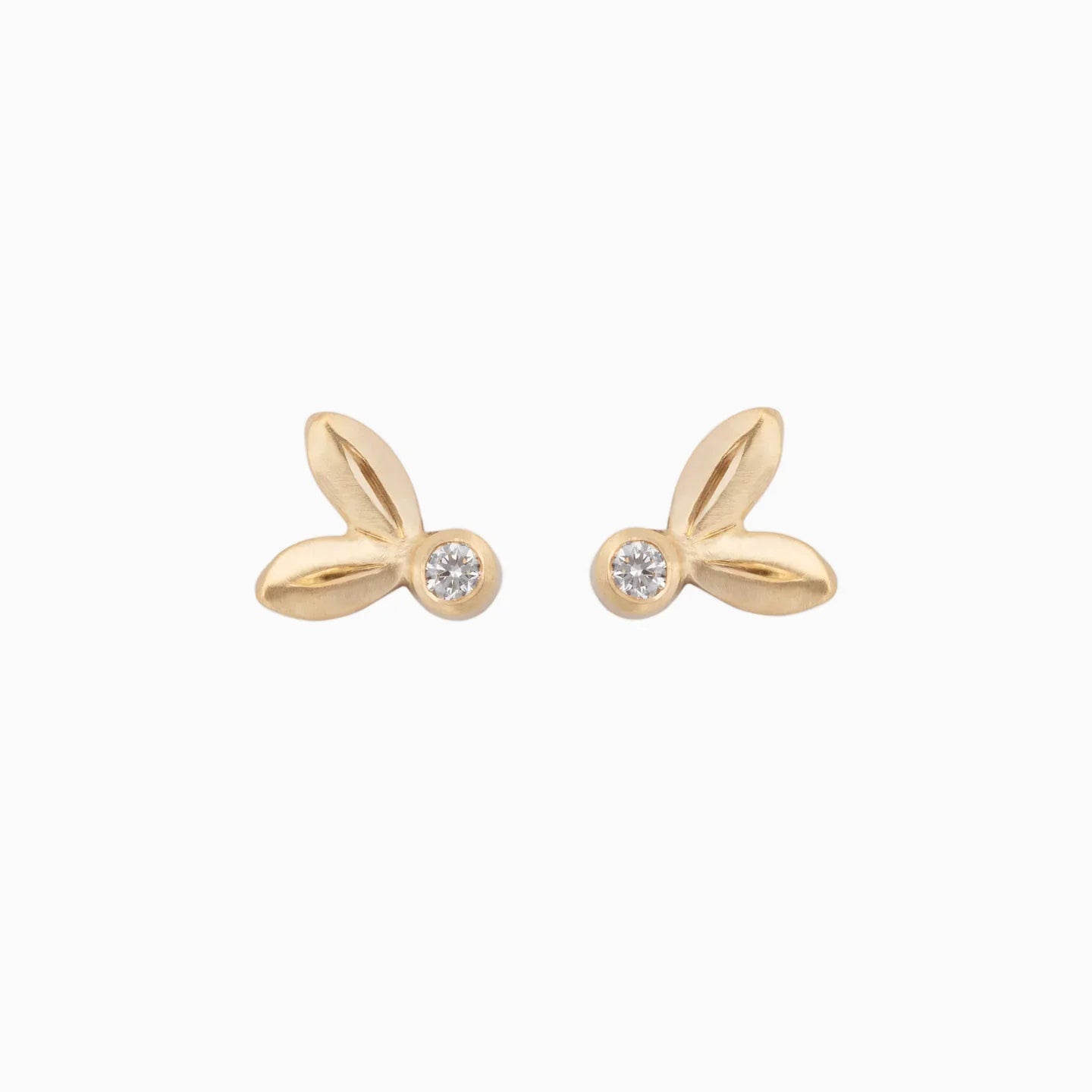 Pair of hand-fabricated 14k gold stud earrings with diamond accents, minimalist white background