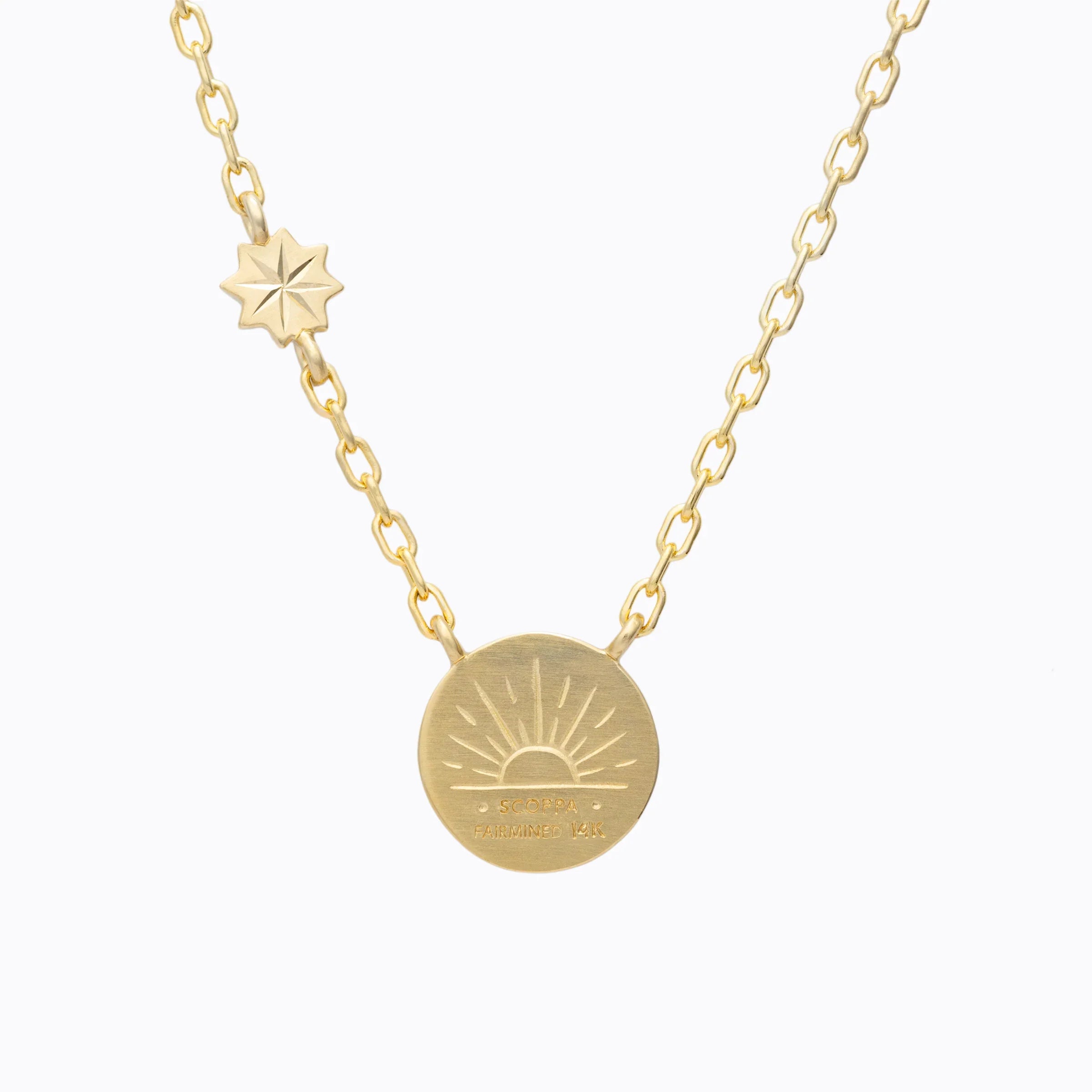 Fairmined 14k gold necklace with sunburst pendant and star charm on delicate chain