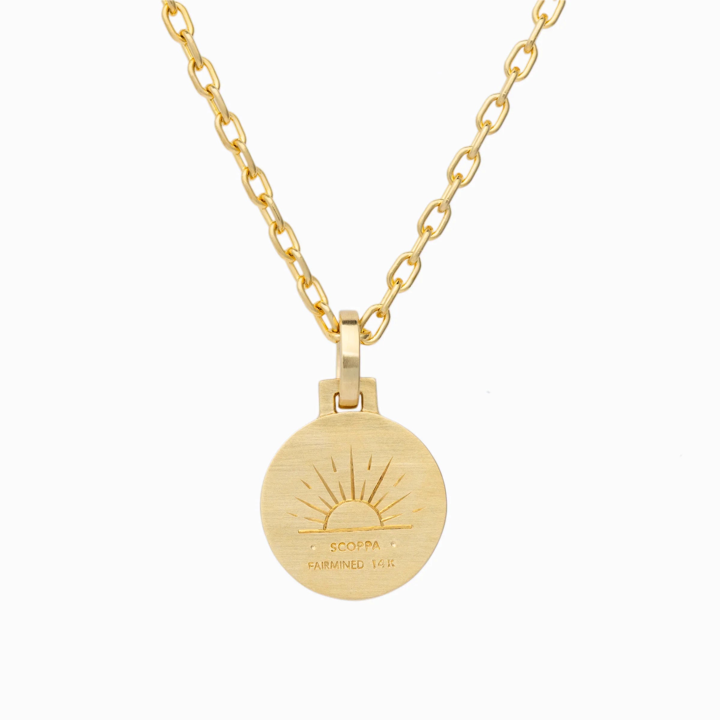 Round gold pendant necklace with engraved sunburst design and Scoppa Fairmined 14k text