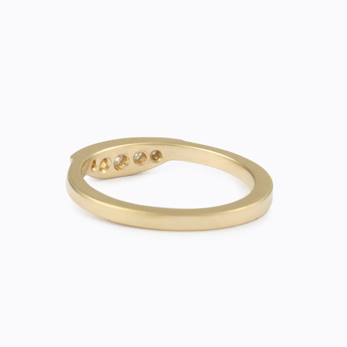 Elegant handcrafted gold ring with five small inset gemstones on clean white background