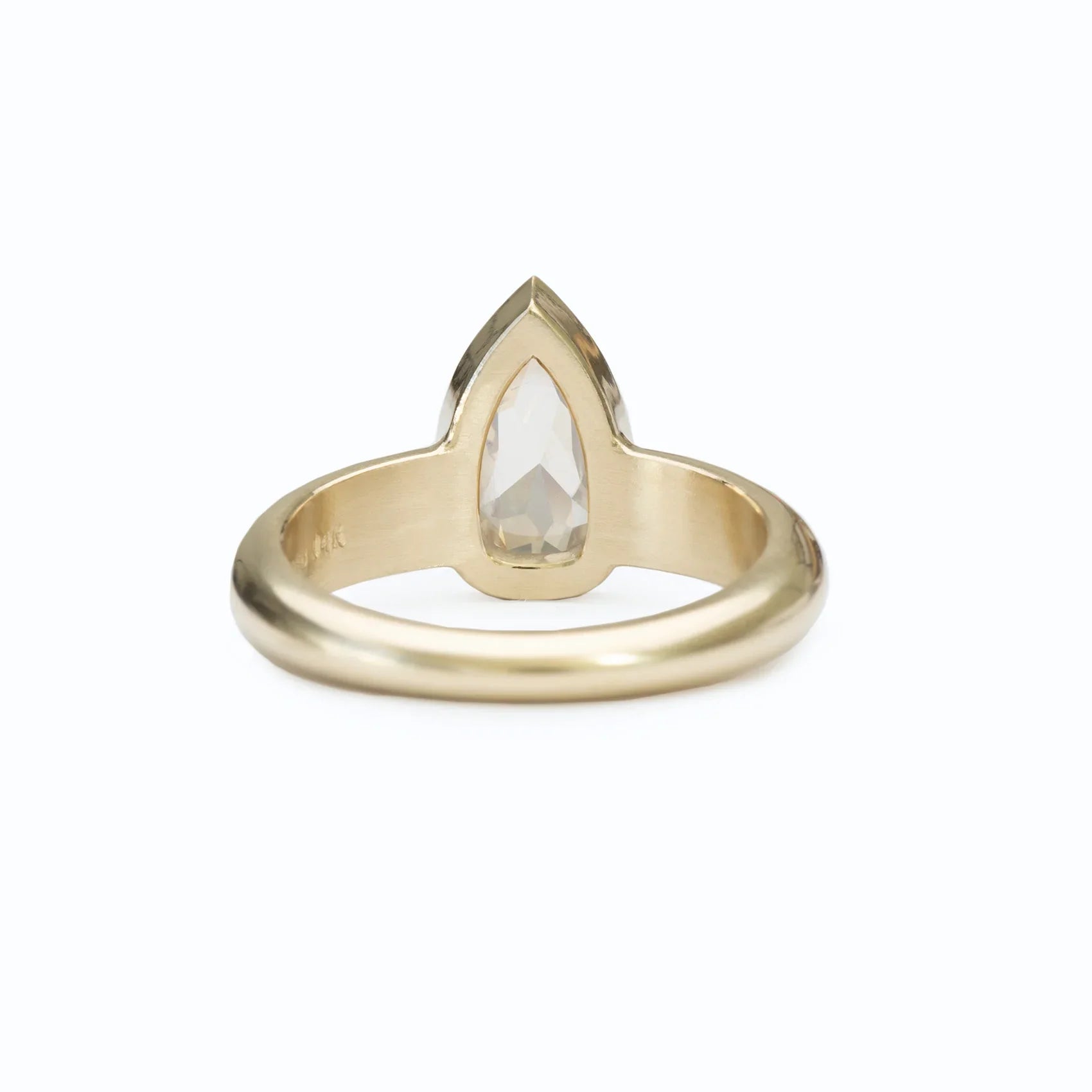 14k gold ring with pear-shaped 0.94ct diamond, elegant minimalist jewelry on white background