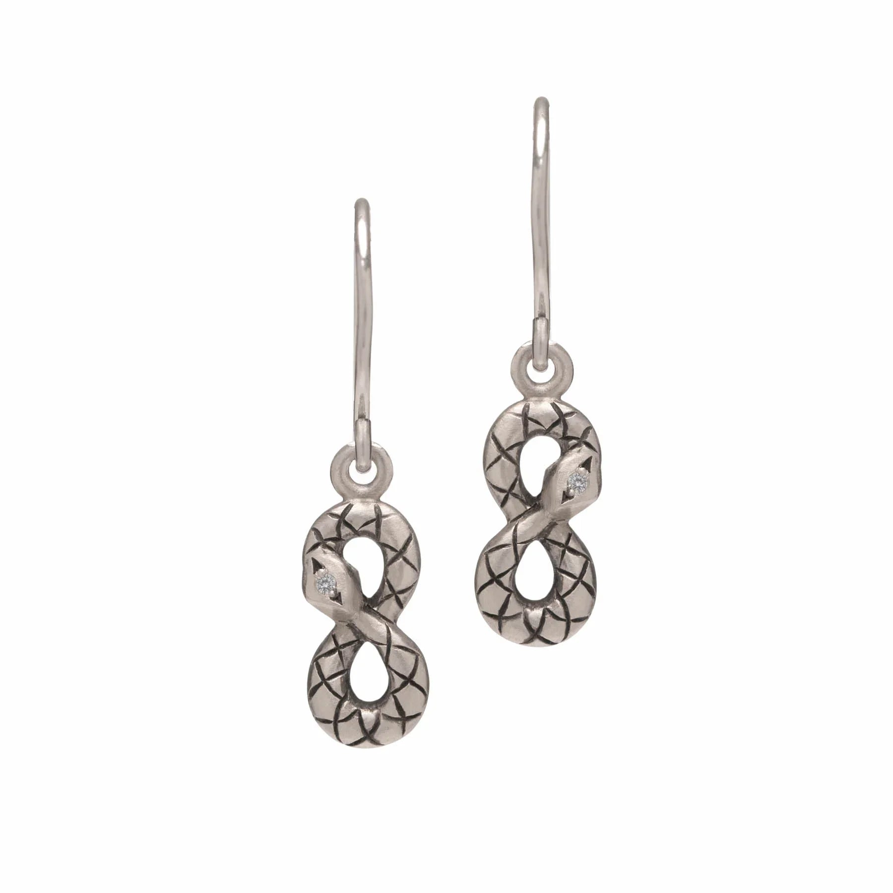 Close-up of silver infinity-shaped snake earrings with engraved scale pattern and small gemstone eyes on white background