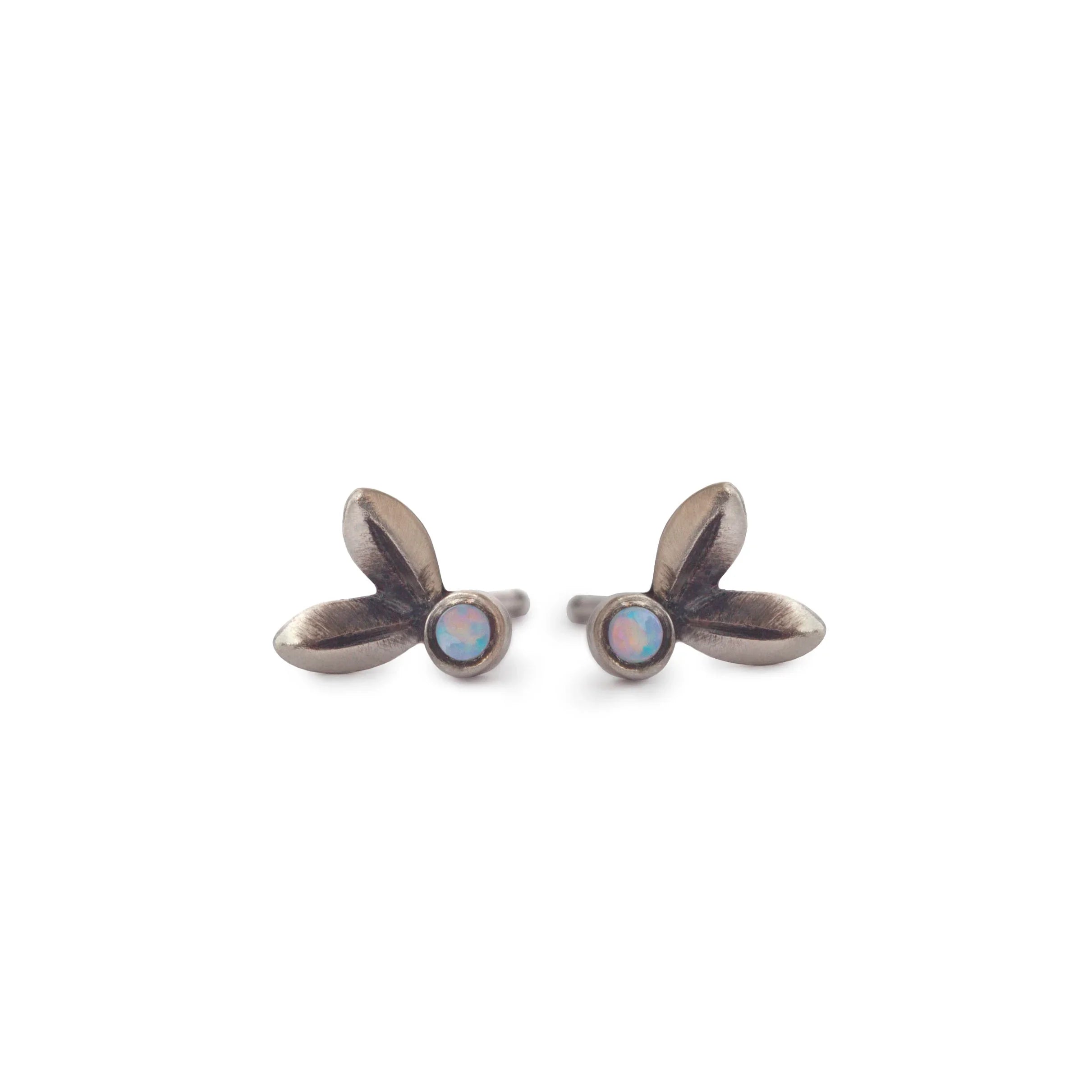 Pair of oxidized silver stud earrings with delicate leaf shapes and round opal cabochons on white background