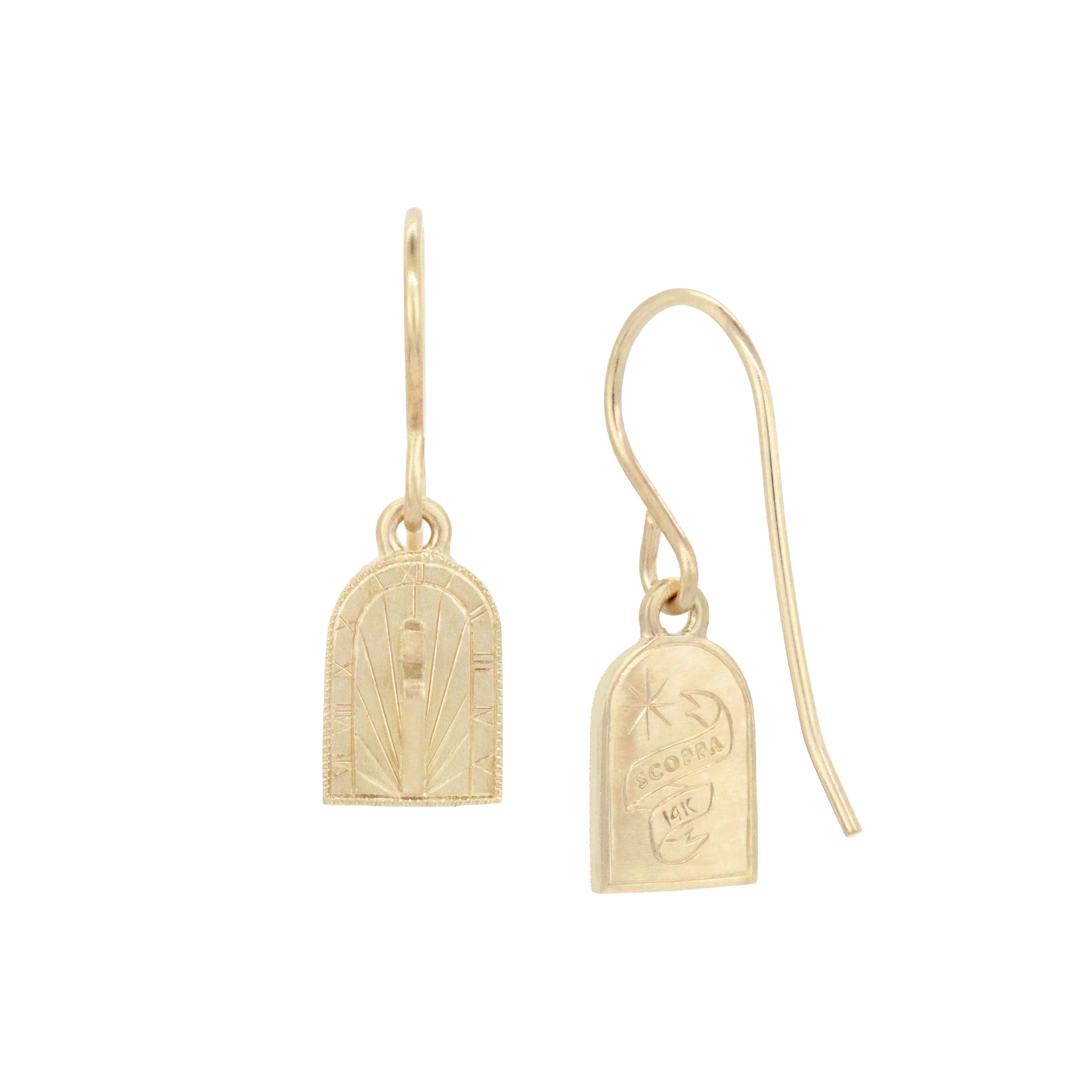 Delicate 14k gold sundial earrings with hand-engraved time markings and warm natural light