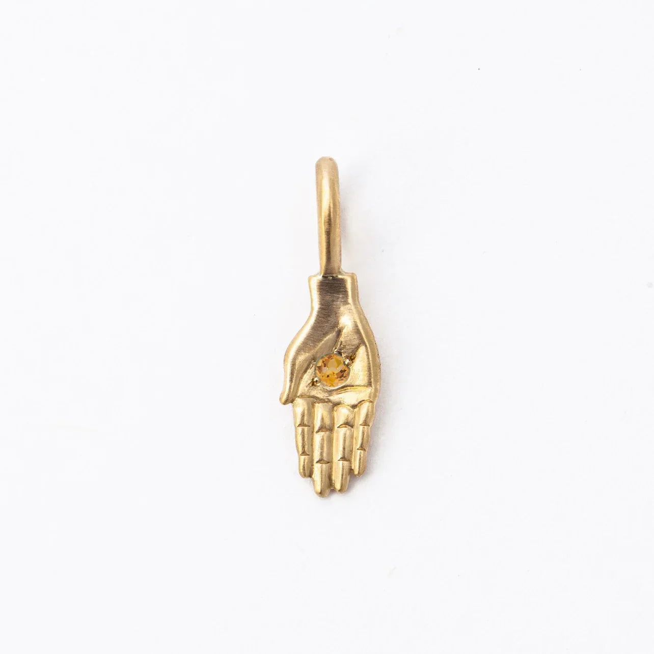 Handcrafted gold hand pendant with faceted golden citrine stone on soft white background