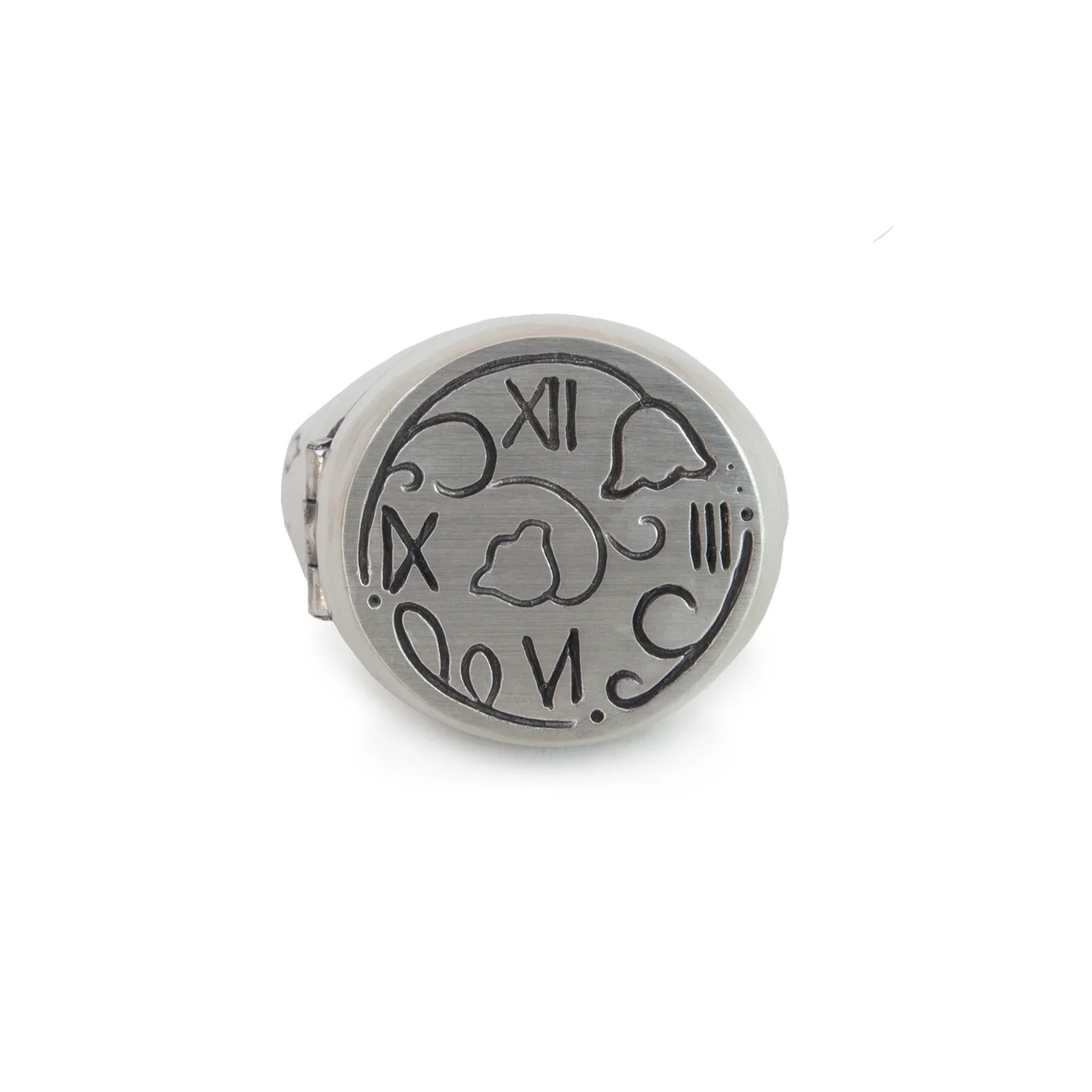 Close-up of hand-engraved silver ring with abstract clock face and Roman numerals on white background