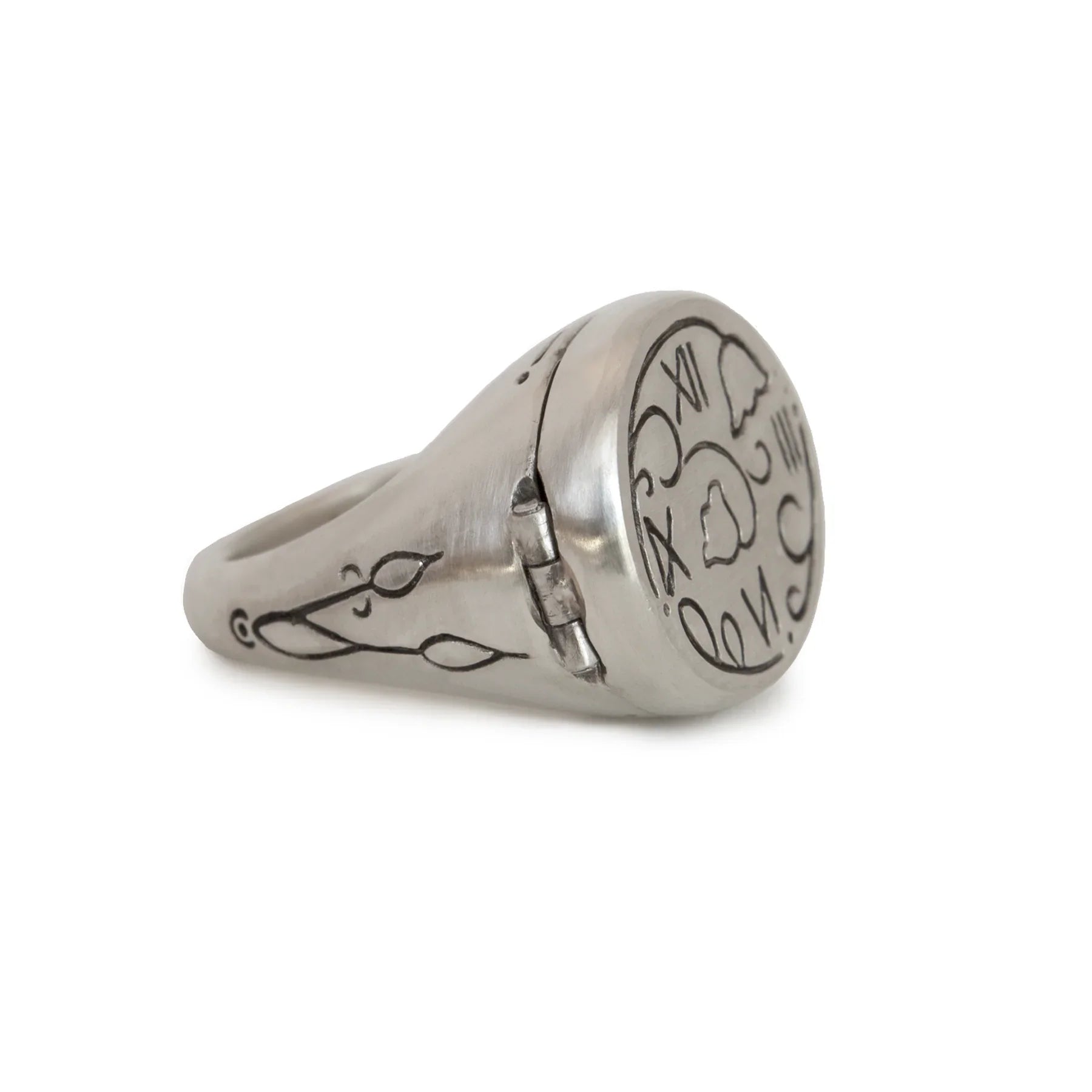 Hand-fabricated silver sundial ring with engraved time markings and floral motifs on white background